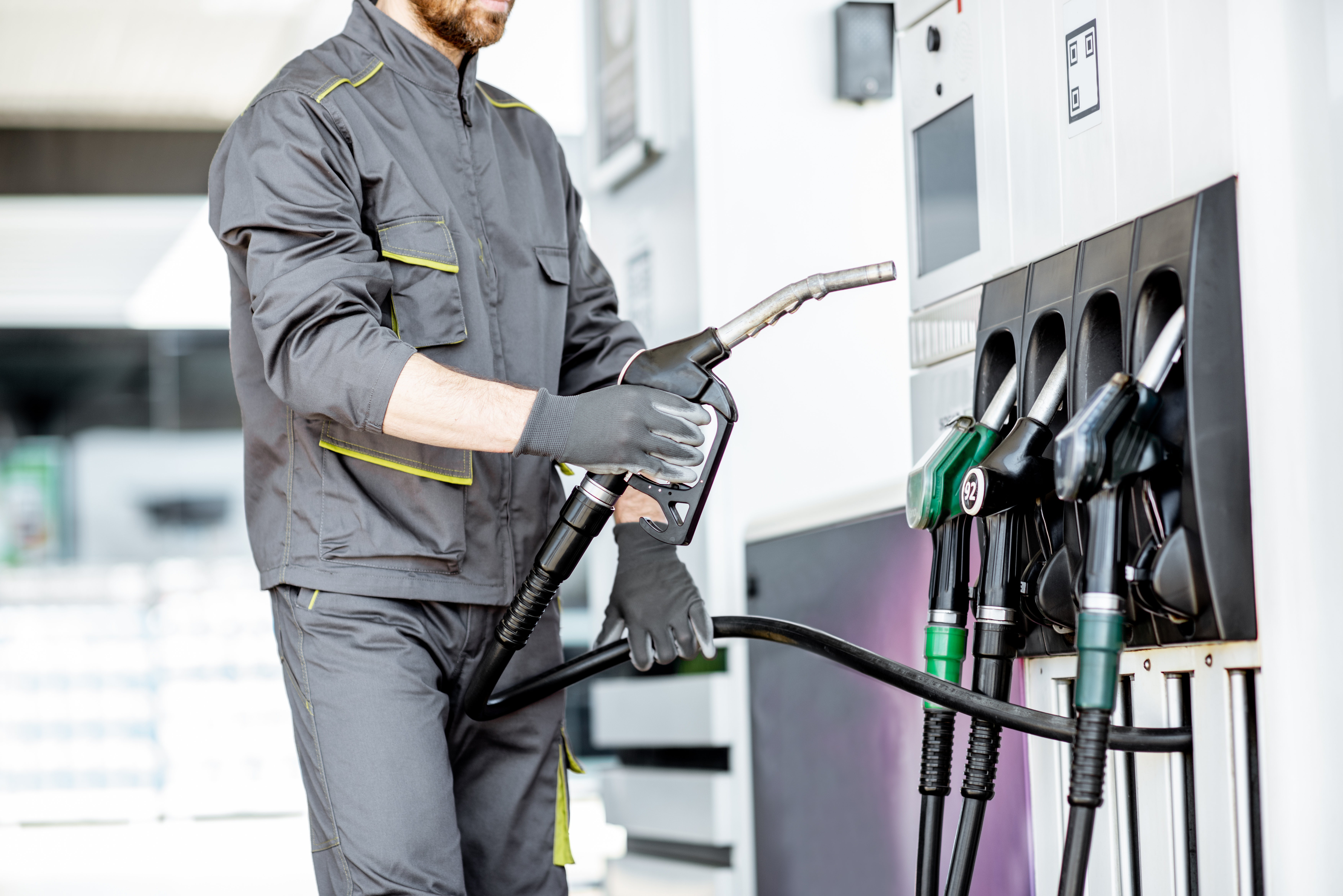Gas station worker refueling car